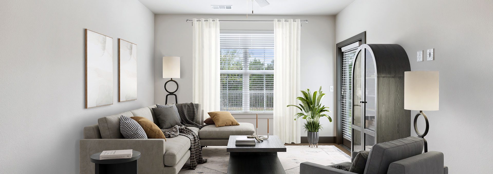 a living room with a ceiling fan and a couch at The La Ventana at Canyon West Apartments